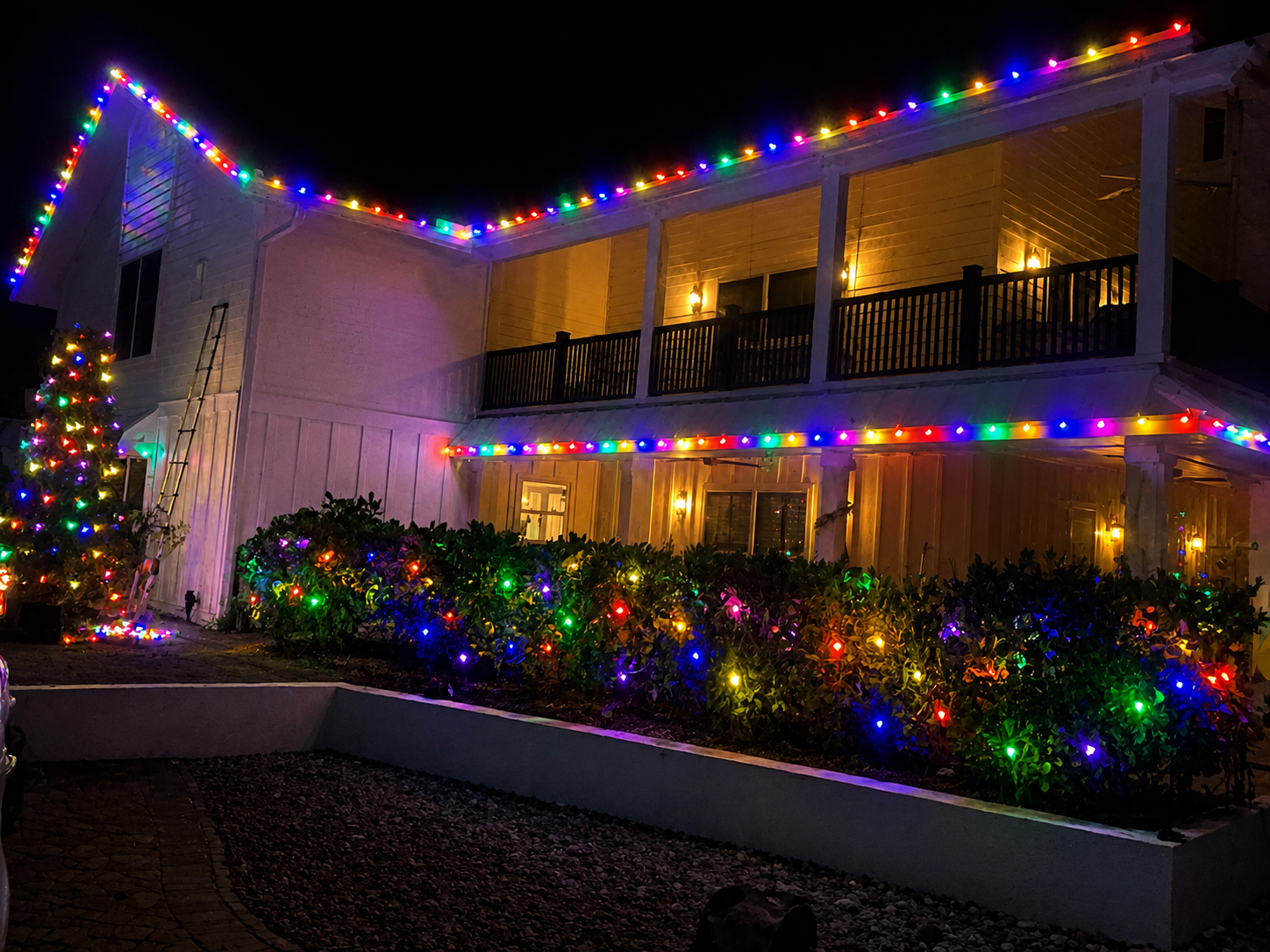 Residential home with multi-color OMNI RGB roofline and landscape lighting
